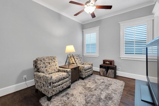 sitting room featuring baseboards, ornamental molding, and wood finished floors