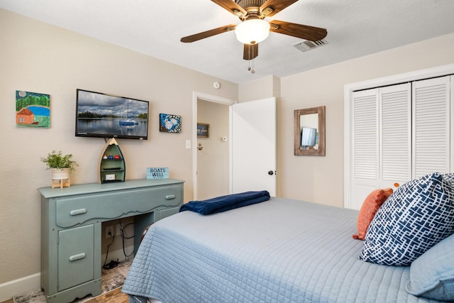 bedroom with a ceiling fan, baseboards, visible vents, and a closet