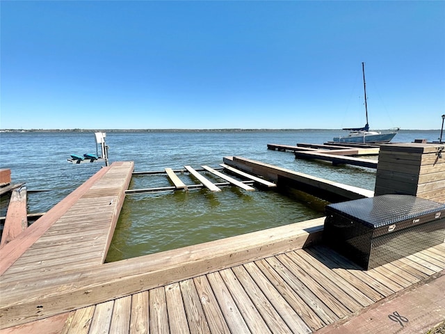 dock area with a water view and boat lift