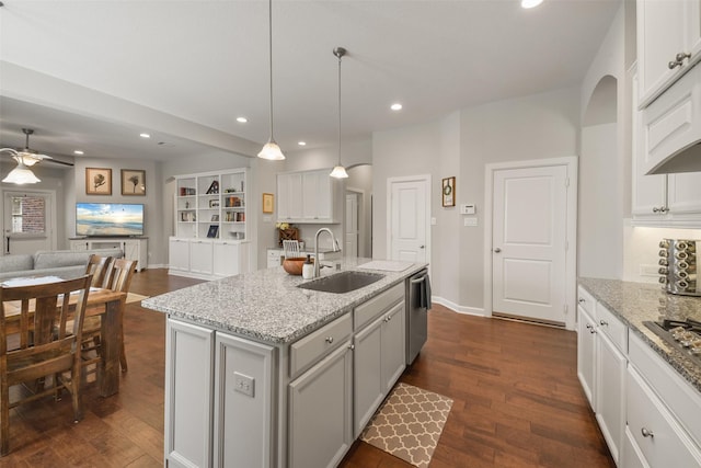 kitchen featuring dark wood-style flooring, stainless steel appliances, recessed lighting, open floor plan, and a sink