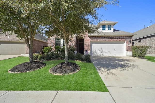 view of front of property with driveway, brick siding, an attached garage, and a front yard