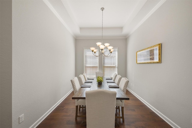 dining area with an inviting chandelier, baseboards, a raised ceiling, and dark wood finished floors