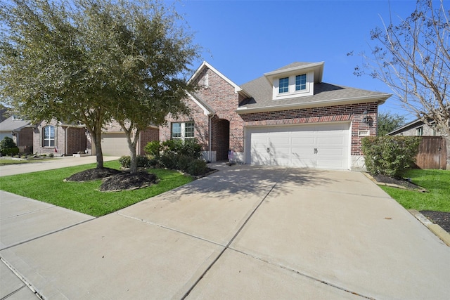 traditional-style house with a garage, brick siding, fence, driveway, and a front yard