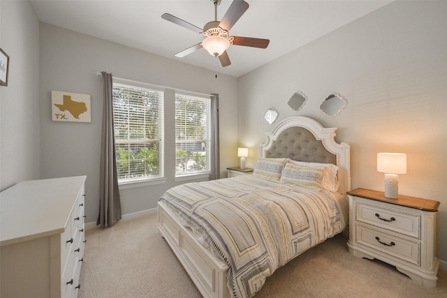 bedroom featuring ceiling fan, baseboards, and light colored carpet