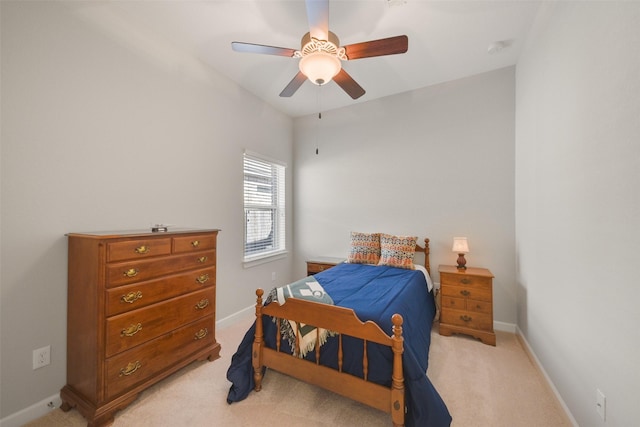 bedroom with light carpet, ceiling fan, and baseboards