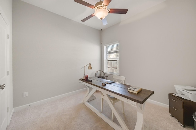 home office with a ceiling fan, light colored carpet, and baseboards