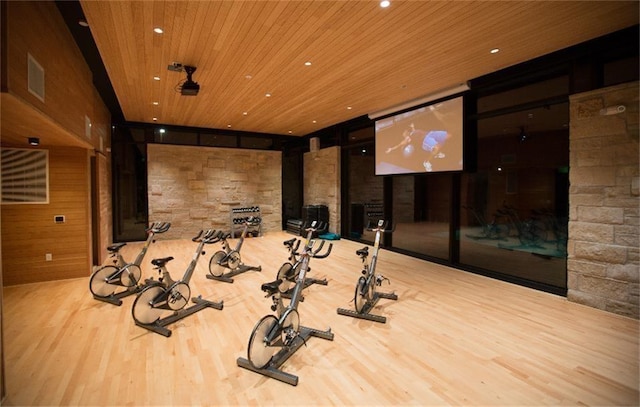 exercise room featuring recessed lighting, visible vents, expansive windows, wood ceiling, and wood finished floors