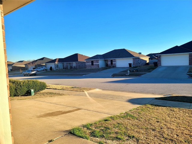 view of yard with a residential view and driveway