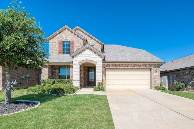 view of front of property featuring driveway, roof with shingles, a front lawn, a garage, and brick siding