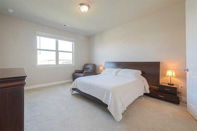 bedroom featuring light colored carpet, visible vents, and baseboards