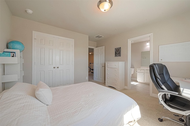 bedroom with baseboards, visible vents, ensuite bath, a closet, and light carpet