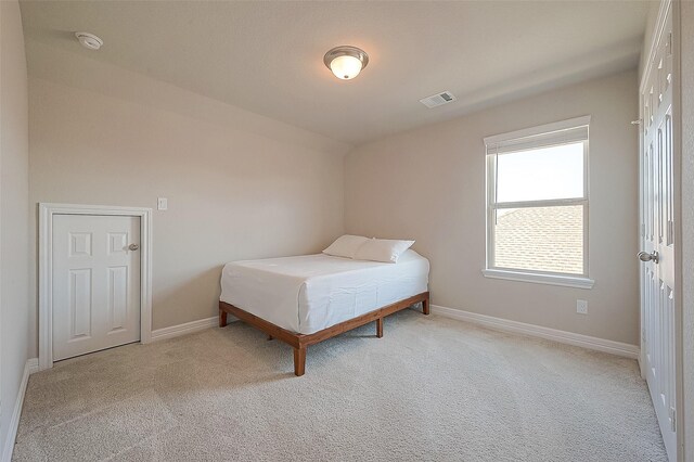 bedroom featuring baseboards, visible vents, and carpet floors