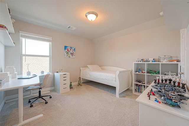 carpeted bedroom with visible vents and baseboards