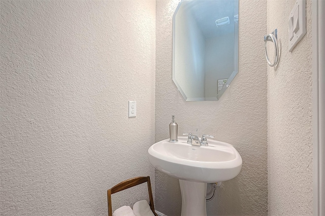 bathroom with a textured wall