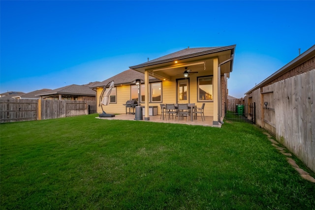 rear view of property with a fenced backyard, a patio area, and a yard