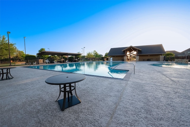 community pool featuring a patio area and fence