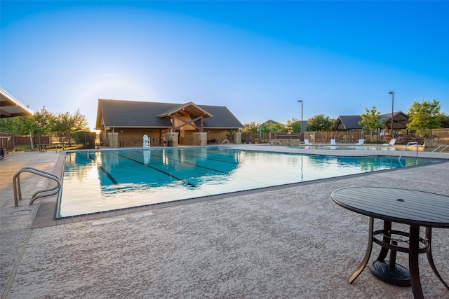 pool featuring fence and a patio area