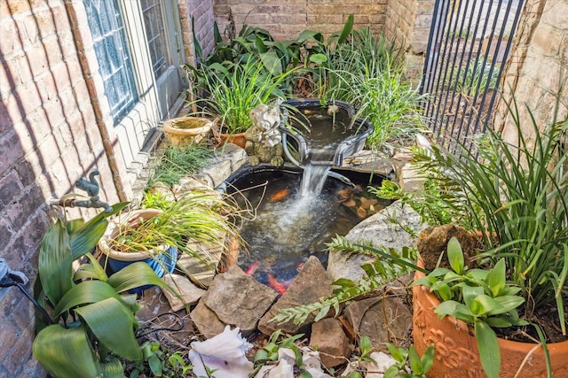 balcony featuring a garden pond