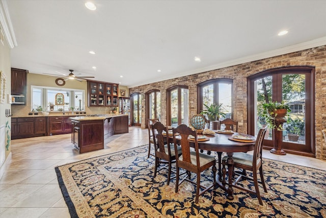 dining area featuring light tile patterned floors, brick wall, ornamental molding, and recessed lighting