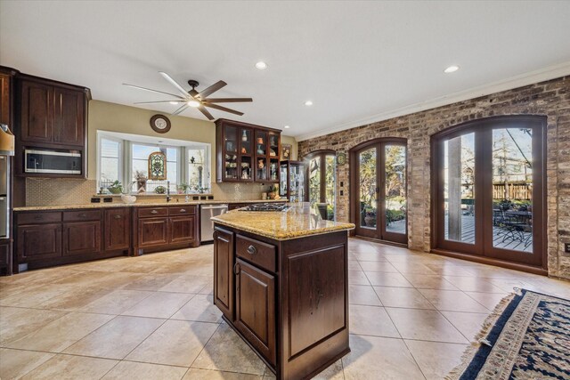 kitchen featuring stainless steel appliances, french doors, backsplash, and light tile patterned floors