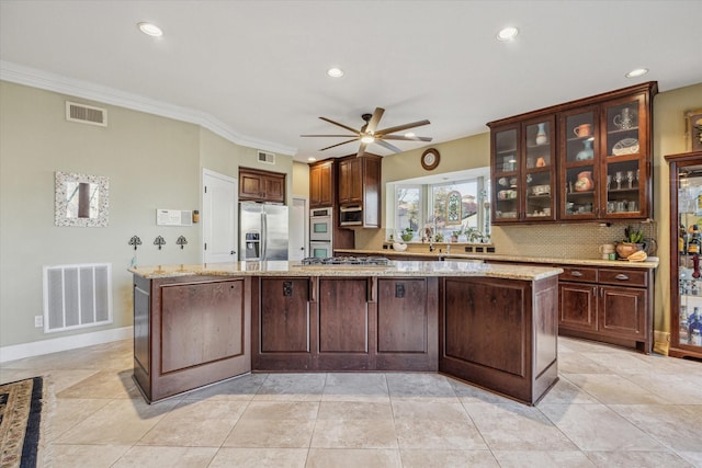 kitchen with stainless steel appliances, visible vents, and a spacious island