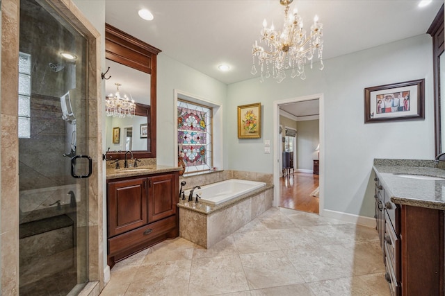 bathroom with a bath, a stall shower, two vanities, and a sink