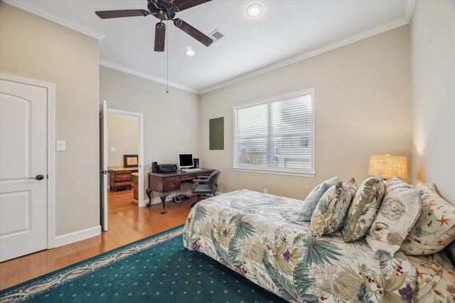 bedroom with ornamental molding, wood finished floors, visible vents, and baseboards