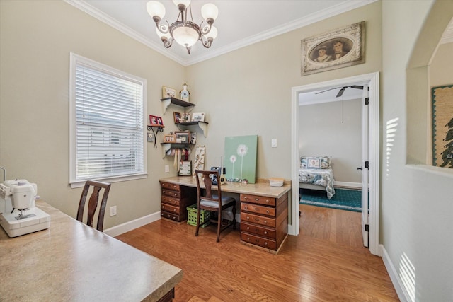 office area featuring a notable chandelier, crown molding, light wood-style flooring, and baseboards