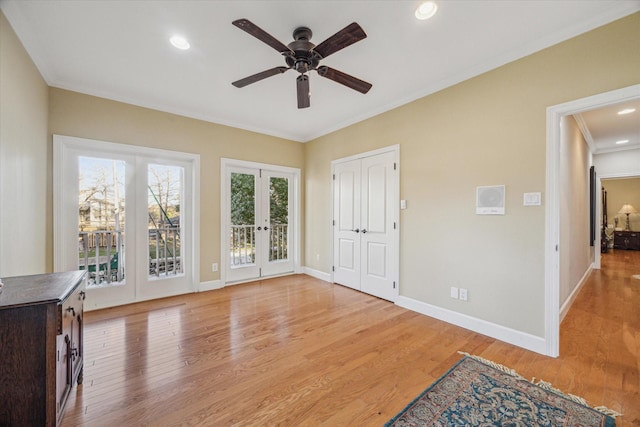 interior space featuring french doors, crown molding, recessed lighting, light wood-style flooring, and baseboards