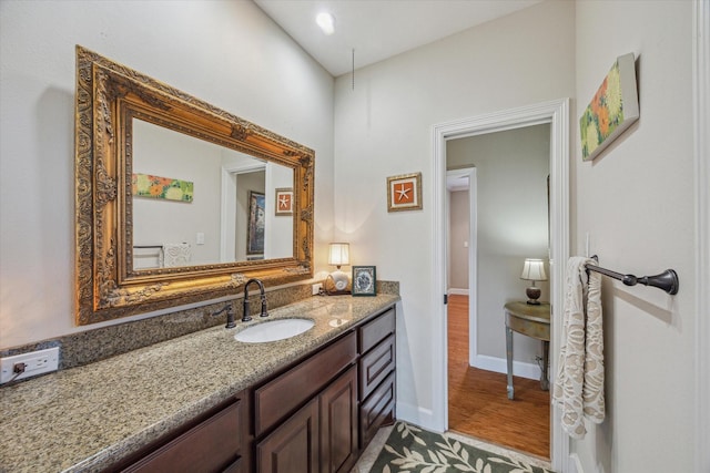 bathroom with vanity and baseboards