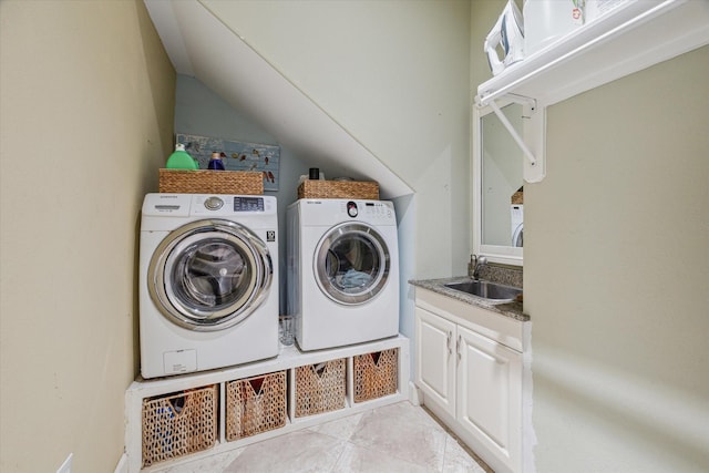 laundry room featuring light tile patterned flooring, a sink, and washer and clothes dryer