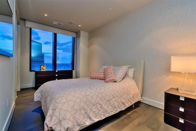 bedroom with visible vents, recessed lighting, baseboards, and wood finished floors