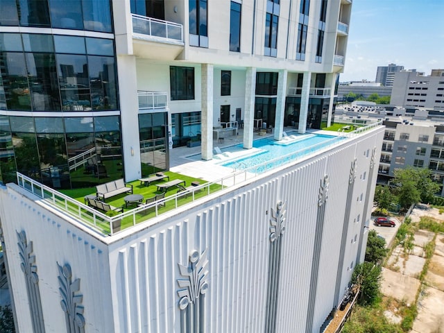 pool featuring a view of city and a patio area