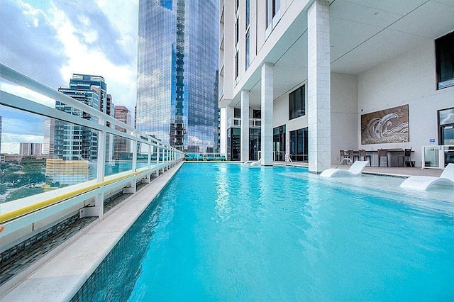 view of swimming pool featuring a city view