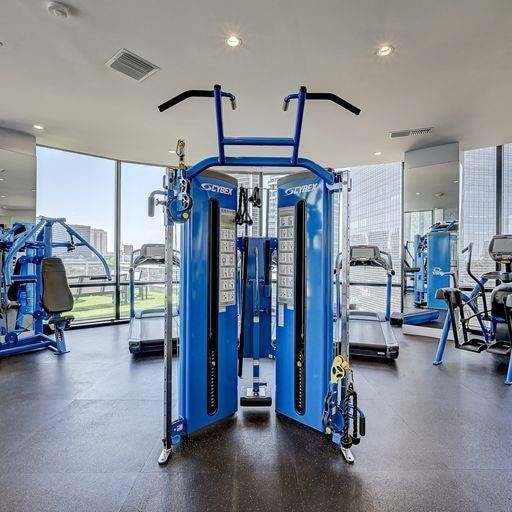 exercise room with visible vents and floor to ceiling windows