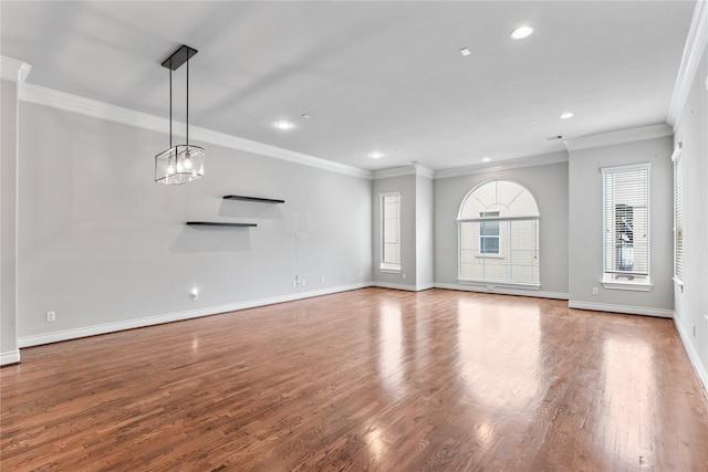 unfurnished living room with recessed lighting, baseboards, wood finished floors, and ornamental molding