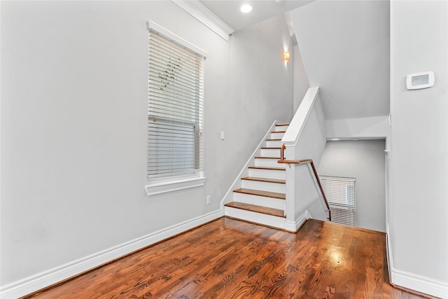 stairs with recessed lighting, wood finished floors, and baseboards