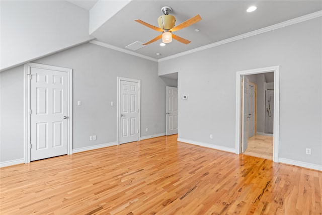 unfurnished bedroom with baseboards, light wood-type flooring, multiple closets, and ornamental molding