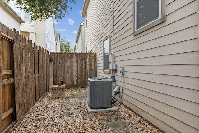 exterior space with fence and central AC