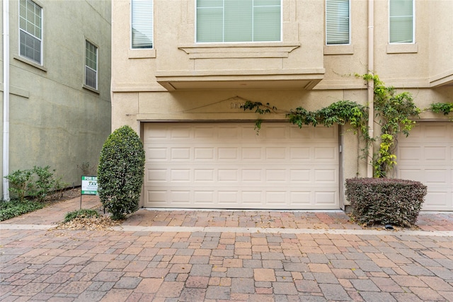 garage with decorative driveway