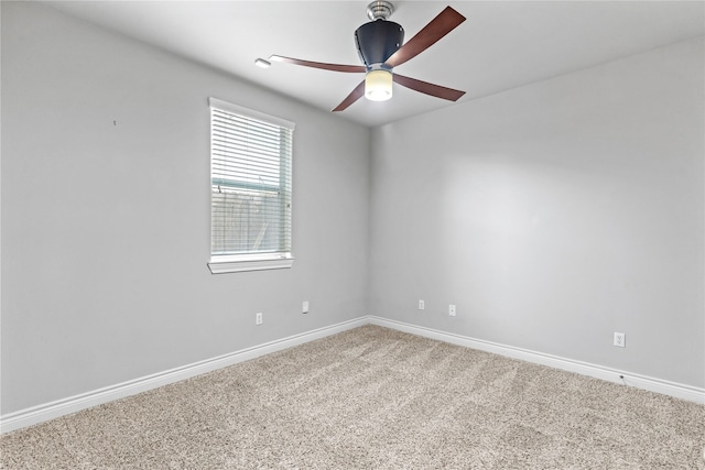 carpeted spare room with baseboards and ceiling fan