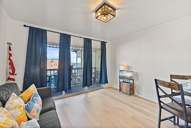 interior space featuring a textured ceiling, wood finished floors, and crown molding