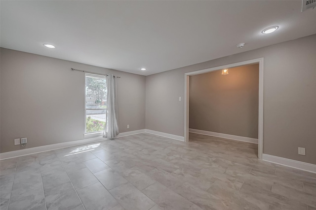 empty room with visible vents, baseboards, and recessed lighting