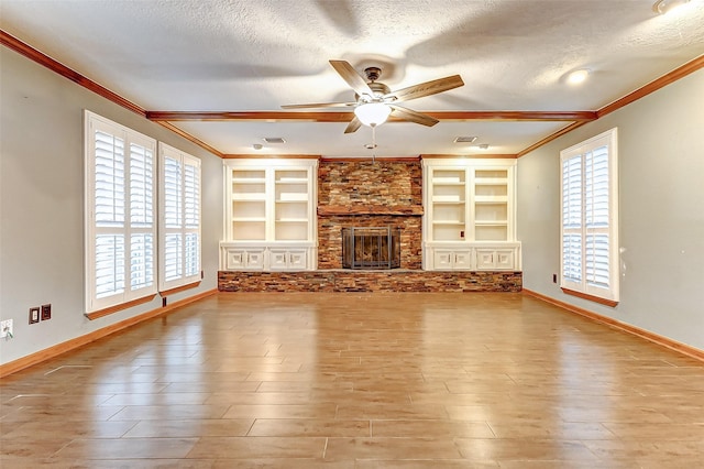 unfurnished living room featuring a fireplace, a textured ceiling, and wood finished floors