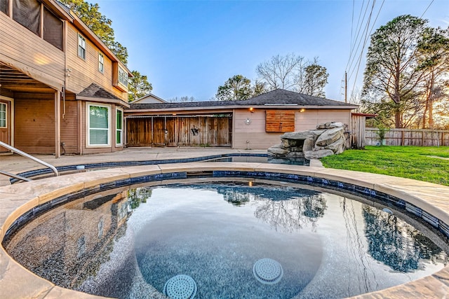 view of swimming pool with a yard, a patio area, fence, and a fenced in pool