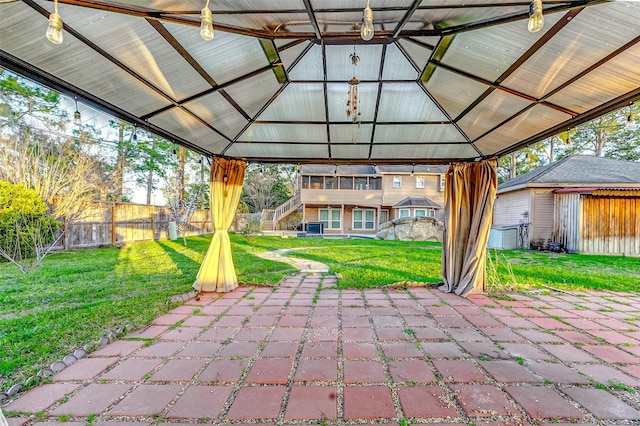 view of patio featuring fence and a gazebo