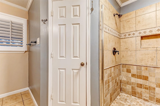 bathroom with ornamental molding, a stall shower, tile patterned flooring, and baseboards