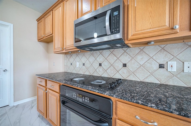 kitchen featuring marble finish floor, black appliances, dark stone countertops, tasteful backsplash, and baseboards