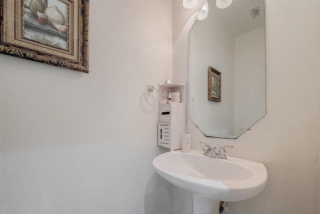 bathroom featuring visible vents and a sink