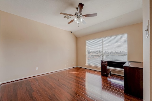 unfurnished room with visible vents, baseboards, vaulted ceiling, wood finished floors, and a ceiling fan